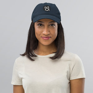 AG - Woman wearing a navy blue cap with text on a gray background