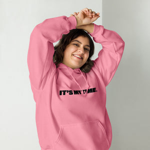 AG - Woman wearing a azalea hoodie with 'IT'S MY TIME' text, smiling against a plain background