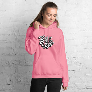 AG - Woman wearing a azalea hoodie with, know your worth, text against a white brick wall.