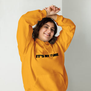 AG - Woman wearing a good hoodie with 'IT'S MY TIME' text, smiling against a plain background