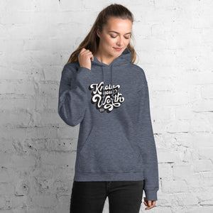 AG - Woman wearing a heahter hoodie with, know your worth, text against a white brick wall.