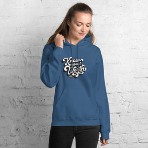AG - Woman wearing a indigo blue hoodie with, know your worth, text against a white brick wall.