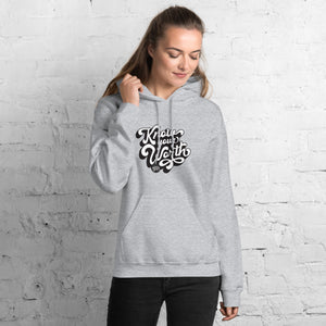 AG - Woman wearing a sport grey hoodie with, know your worth, text against a white brick wall.