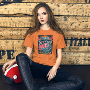 AG - Woman wearing a burnt orange t-shirt with, stronger than you realize, graphic design sitting against a wooden wall.