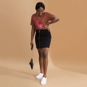 AG - Woman wearing a heather clay t-shirt, with a tiger graphic design, on a beige background