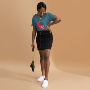 AG - Woman wearing a heather deep teal t-shirt, with a tiger graphic design, on a beige background