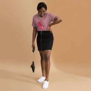 AG - Woman wearing a heather orchid t-shirt, with a tiger graphic design, on a beige background