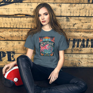 AG - Woman wearing a heather slate t-shirt with, stronger than you realize, graphic design sitting against a wooden wall.