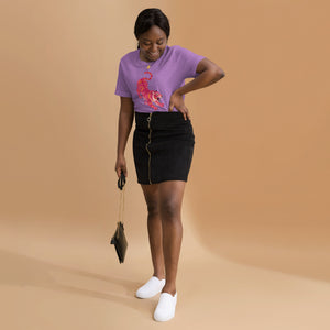 AG - Woman wearing a heather team purple t-shirt, with a tiger graphic design, on a beige background