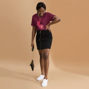 AG - Woman wearing a maroon t-shirt, with a tiger graphic design, on a beige background