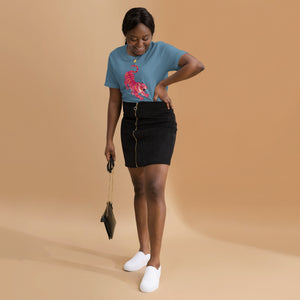AG - Woman wearing a steel blud t-shirt , with a tiger graphic design, on a beige background